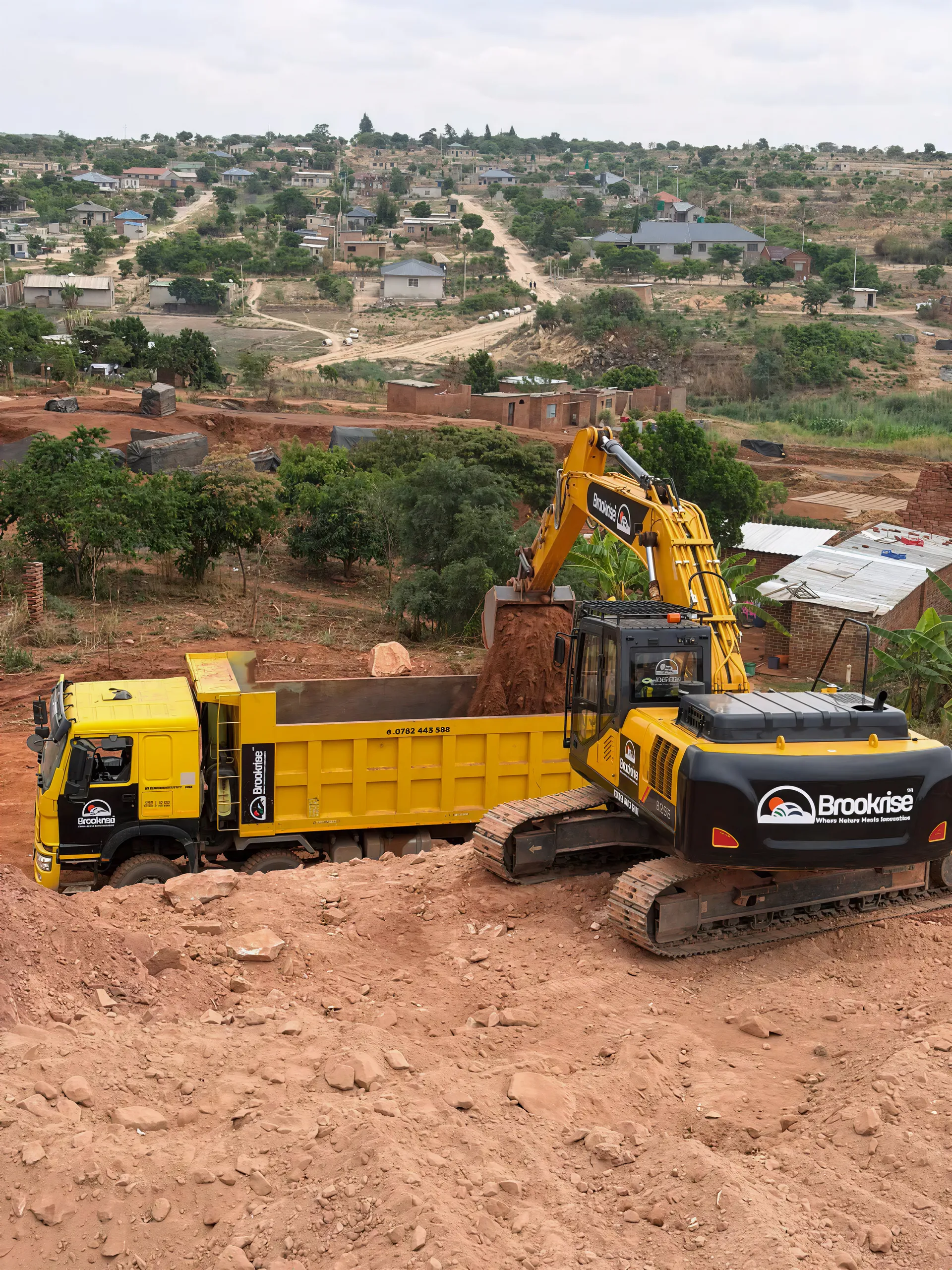 Brookrise excavator dump truck loading site wide action shot